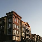 Modern multi-story residential apartment building in the Pacific Crest Reserves community with contemporary architecture and large windows.