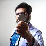 person in white long sleeve shirt holding magnifying glass